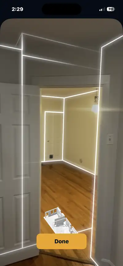 EdgeFloor mid-scan, outlining the walls of a hallway and bedroom doorway